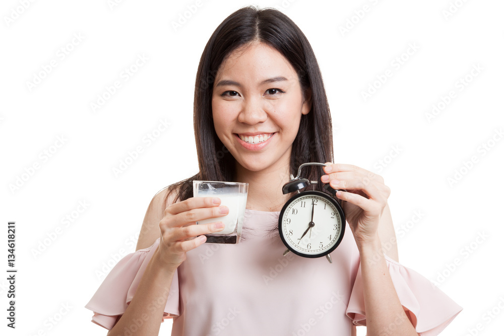 Healthy Asian woman drinking glass of milk hold clock. Healthy Asian woman drinking glass of milk hold clock.