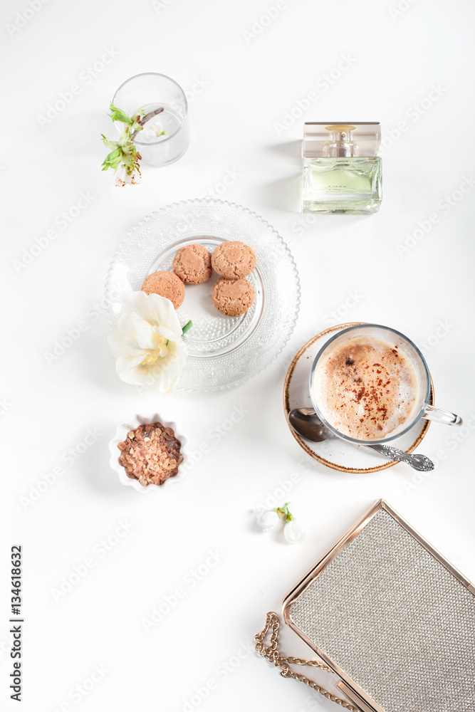 Cup of cappuccino set with cookies, cherry blossoms and perfume Cup of cappuccino set with cookies, cherry blossoms and perfume