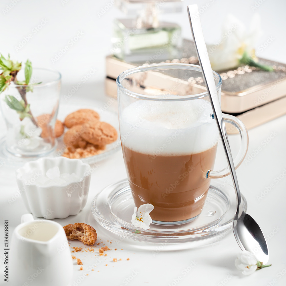 Cup of cappuccino set with cookies, cherry blossoms and perfume Cup of cappuccino set with cookies, cherry blossoms and perfume