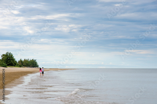 Couple Lovers walking on the sea beach with copy space for label text