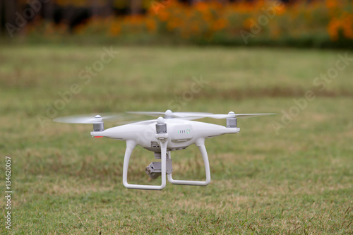 Drone flying in the field beautiful and drone white color