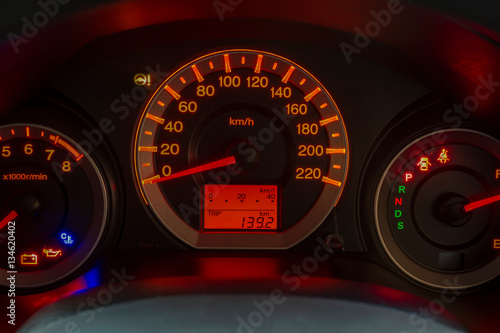 Closeup of a tachometer and speedometer on a sports car dashboard