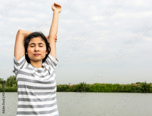beautiful asian woman standing and relax near lake 