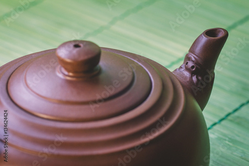 Wallpaper Mural Close-up ceramic brown  chinese  teapot on green bamboo wooden background.Selective focus. Torontodigital.ca