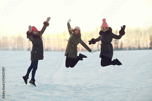 group of girls winter nature fun jump