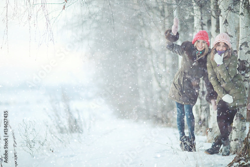 Group of a stylish young girlfriends walking outdoors in winter