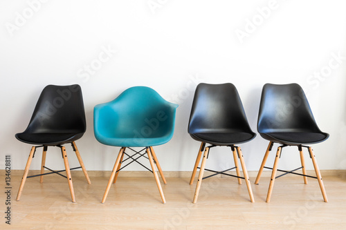 Blue comfortable chair among black. photo