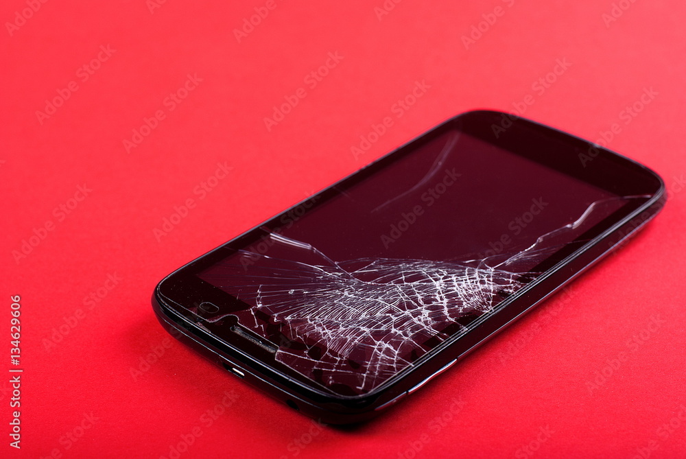 phone with a broken screen on the table phone with a broken screen on the table