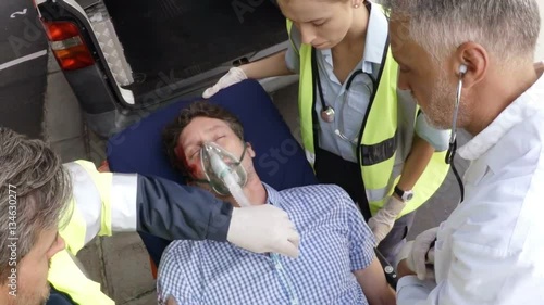 Paramedic using an external defibrillator 