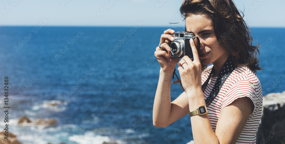 Tourist traveler photographer taking pictures sea scape on vintage photo camera on background yacht and boat piar, hipster girl enjoying mountain and nature holiday, mockup ocean waves view Tourist traveler photographer taking pictures sea scape on vintage photo camera on background yacht and boat piar, hipster girl enjoying mountain and nature holiday, mockup ocean waves view