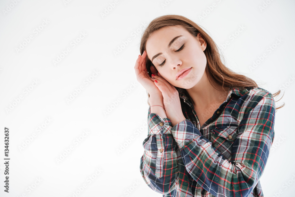 Tender woman with eyes closed standing and touching her face Tender woman with eyes closed standing and touching her face