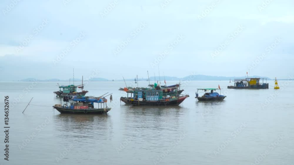 Group of traditional Vietnamese boats in the bay. Asian region. South China Sea. Vietnam travel landscape and destinations. Group of traditional Vietnamese boats in the bay. Asian region. South China Sea. Vietnam travel landscape and destinations.