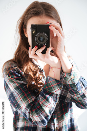 Young lady photographer using camera