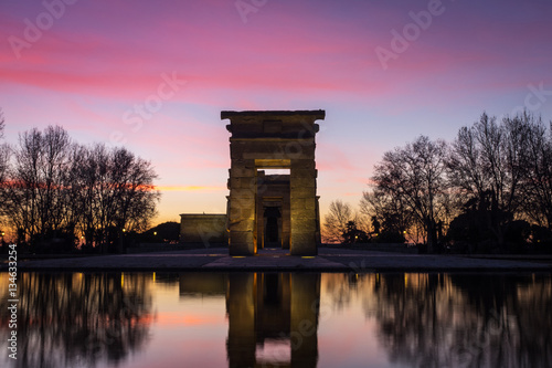 Illuminated Temple of Debod and reflection during sunset in Madr