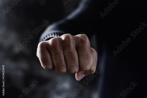 young man with his fist clenched