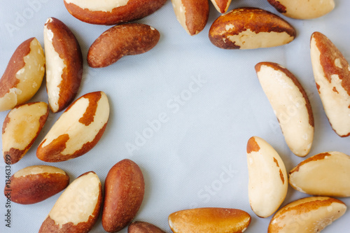 Brazil nuts over the white fabric material.