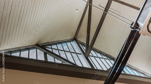 Glass gable (triangular end of a roof) roof top interior house decorate with a black steel frame in vintage style.