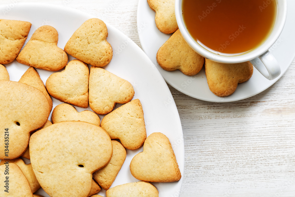 Closeup heart-shaped cookies and a cup of tea Closeup heart-shaped cookies and a cup of tea