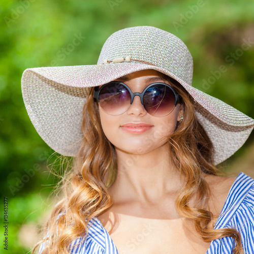 portrait of a beautiful young girl in a hat. beautiful girl on the beach alone