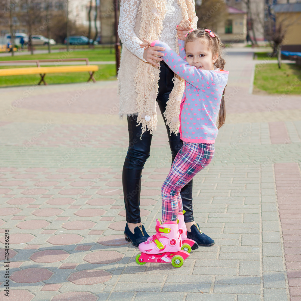 Mom And Daughter Ride On Roller Skates Girl Learning To Roller Skate