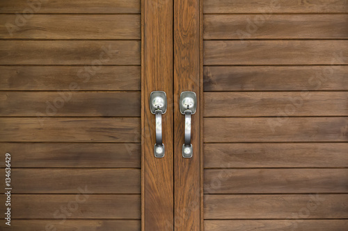 Aluminium door knob on the modern wooden door