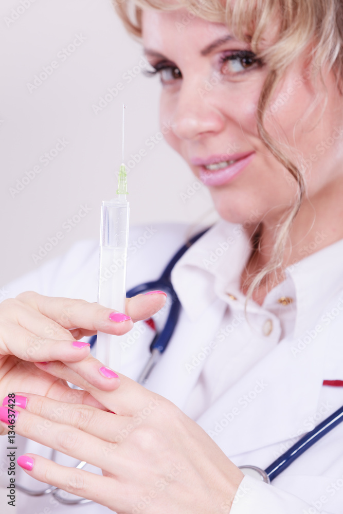 Blonde doctor with syringe. Blonde doctor with syringe.