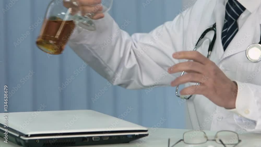 Exhausted doctor drinking alcohol at clinic office, irresponsible medical worker Exhausted doctor drinking alcohol at clinic office, irresponsible medical worker