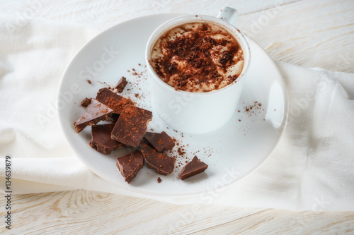 Mug of cocoa and chocolate on a plate