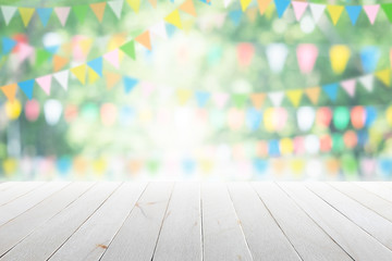 Empty wooden table with party in garden background blurred.