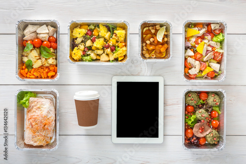 Healthy food online order in boxes, top view at wood