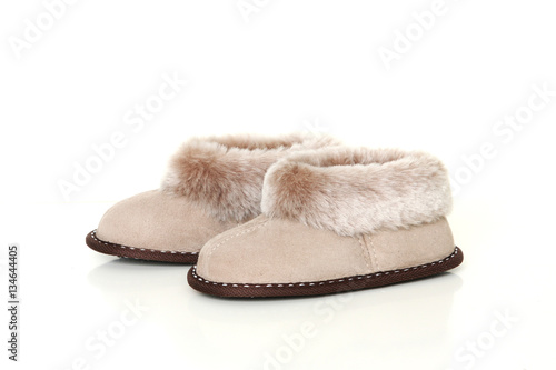 Kid’s sheepskin slippers isolated on white background