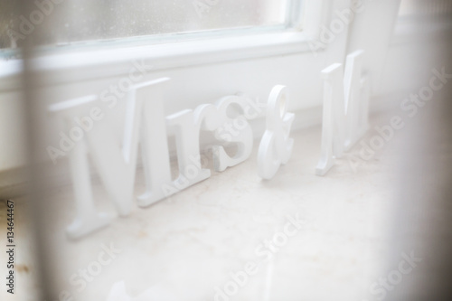 White letterings 'Mrs & Mr' stand on white windowsill