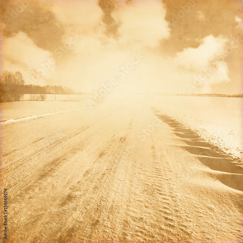 Grunge photo of empty winter road.