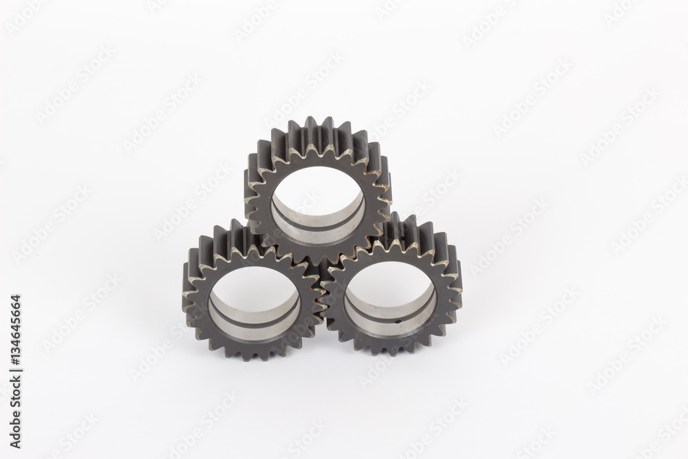 Small group of gears with their teeth engaged on a white background. Small group of gears with their teeth engaged on a white background.