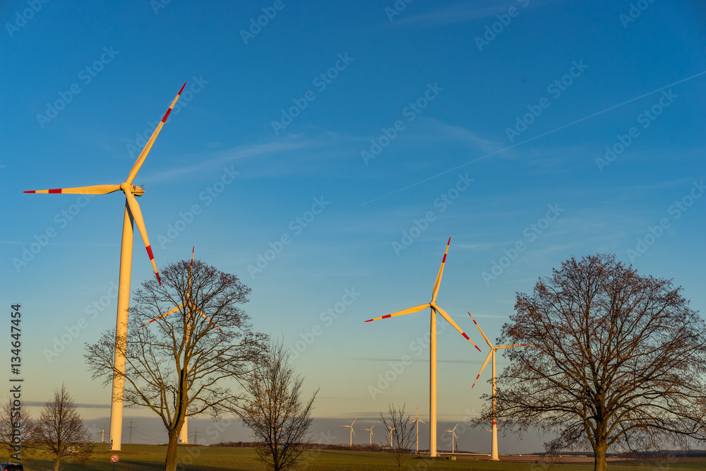 electric wind turbines on a field during sunset electric wind turbines on a field during sunset