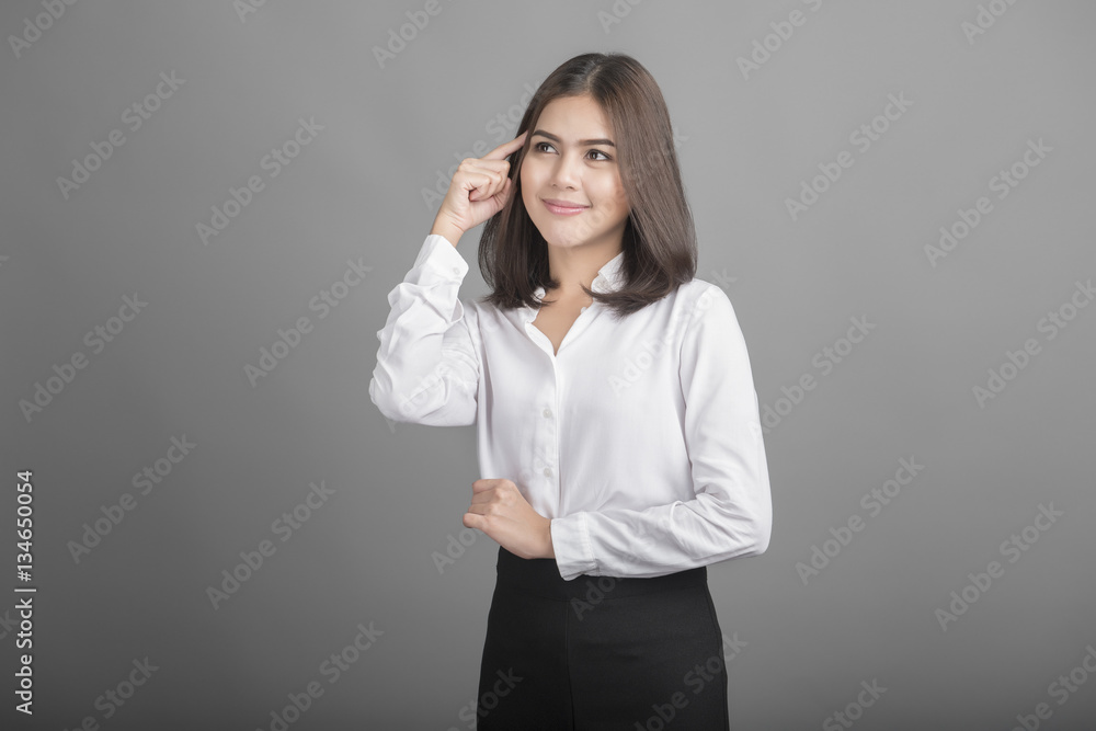 Beautiful Business Woman thinking on grey background Beautiful Business Woman thinking on grey background
