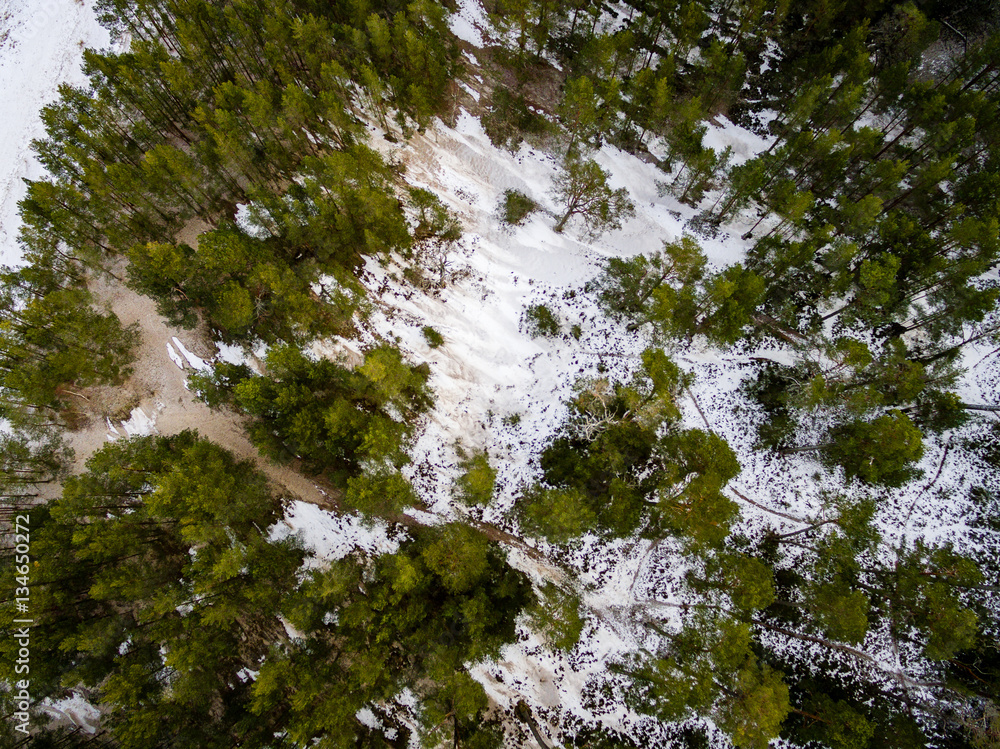 aerial view of frozen forest lake in winter aerial view of frozen forest lake in winter