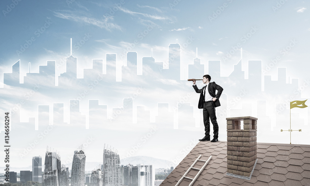 Engineer man standing on roof and looking in spyglass. Mixed med Engineer man standing on roof and looking in spyglass. Mixed med