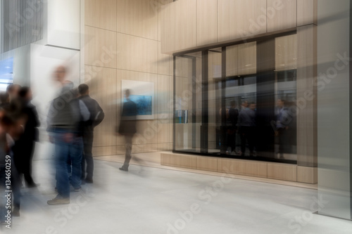 Blurred business people on trade fair stand
