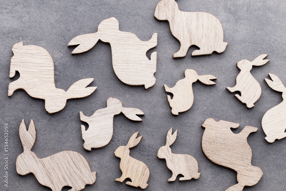 Handmade wood easter rabbits on wooden background. Handmade wood easter rabbits on wooden background.