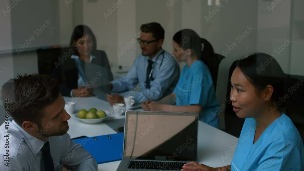 Doctor interacting with colleagues in meeting at conference room 4k Doctor interacting with colleagues in meeting at conference room 4k
