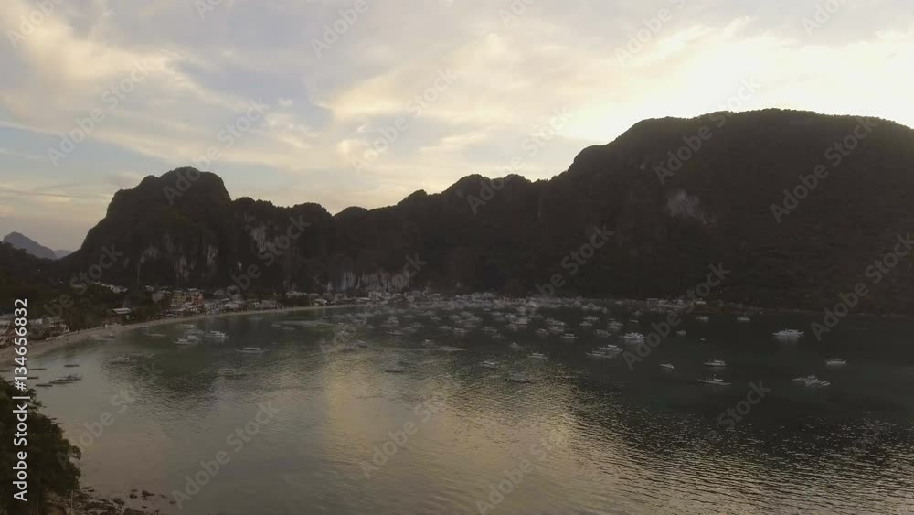 Aerial view of sailing boats and yachts in the bay.Tropical bay in El Nido sunset.Aerial view:tropical landscape.Sunset sky and mountains rocks of bay.Dreamy sunset among the rocks.Aerial video Aerial view of sailing boats and yachts in the bay.Tropical bay in El Nido sunset.Aerial view:tropical landscape.Sunset sky and mountains rocks of bay.Dreamy sunset among the rocks.Aerial video