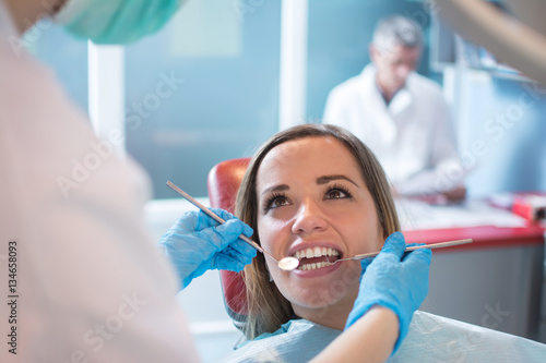 Dentist examining a patient's teeth in the dental office.