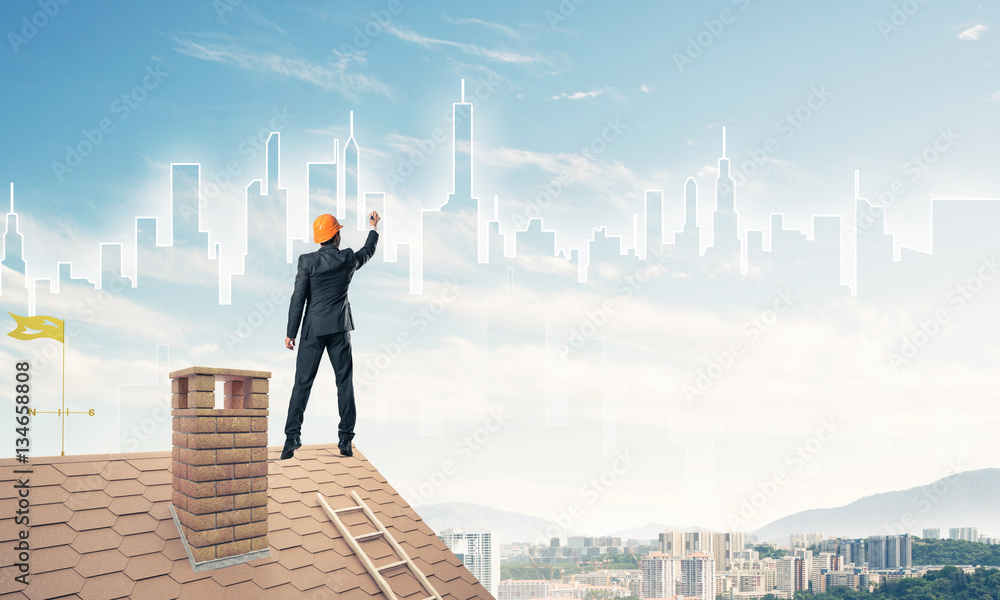 Man architect draw silhouette of modern city on blue sky. Mixed Man architect draw silhouette of modern city on blue sky. Mixed
