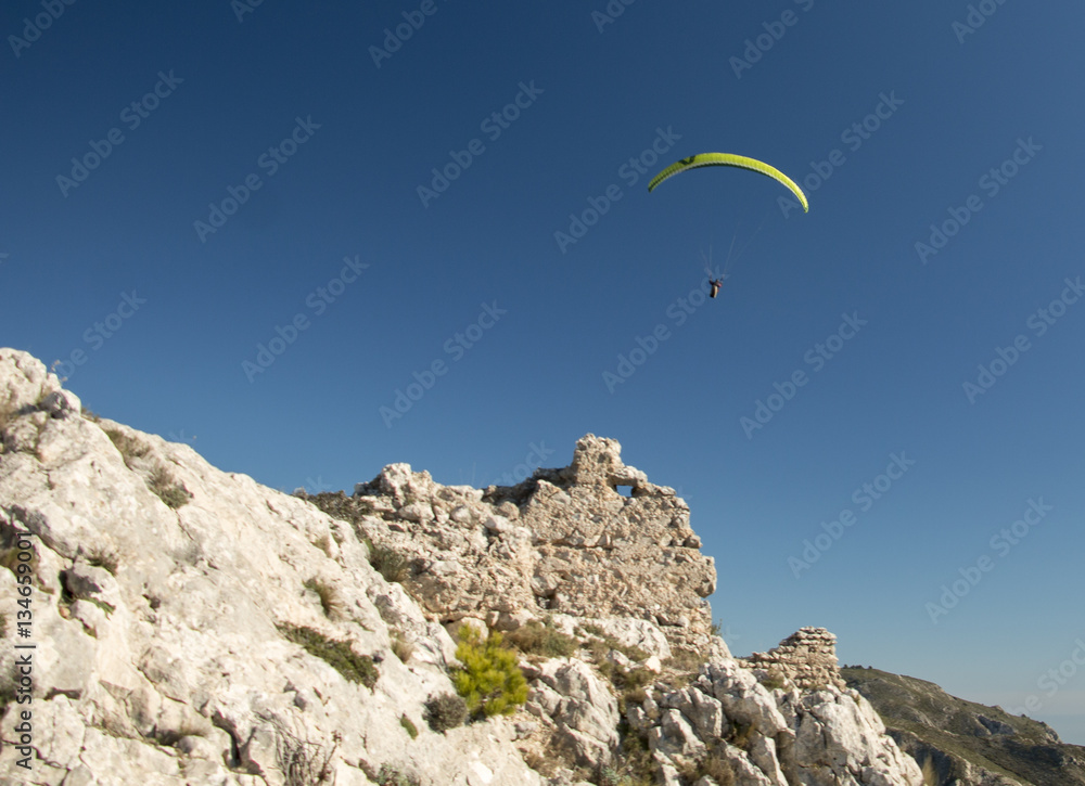 Paraglider visiting ruins of an old castle Paraglider visiting ruins of an old castle