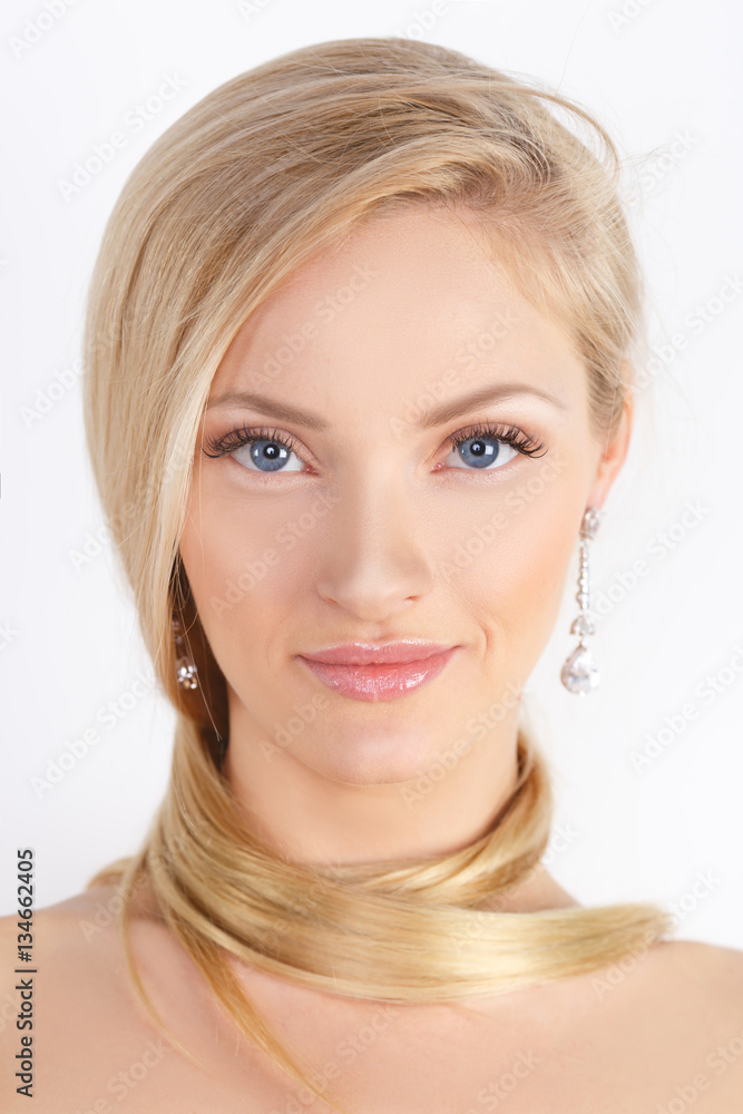 Fototapeta premium Beauty Spa Woman with perfect face skin Portrait. Beautiful blonde Isolated on white. Natural make-up, blue eyes, pink gloss on her lips, long eyelashes