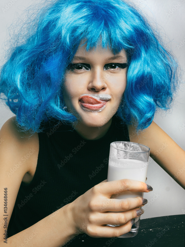 Girl drining milk Girl in a blue wig drinking milk from a glass Close-up  Stock Photo | Adobe Stock