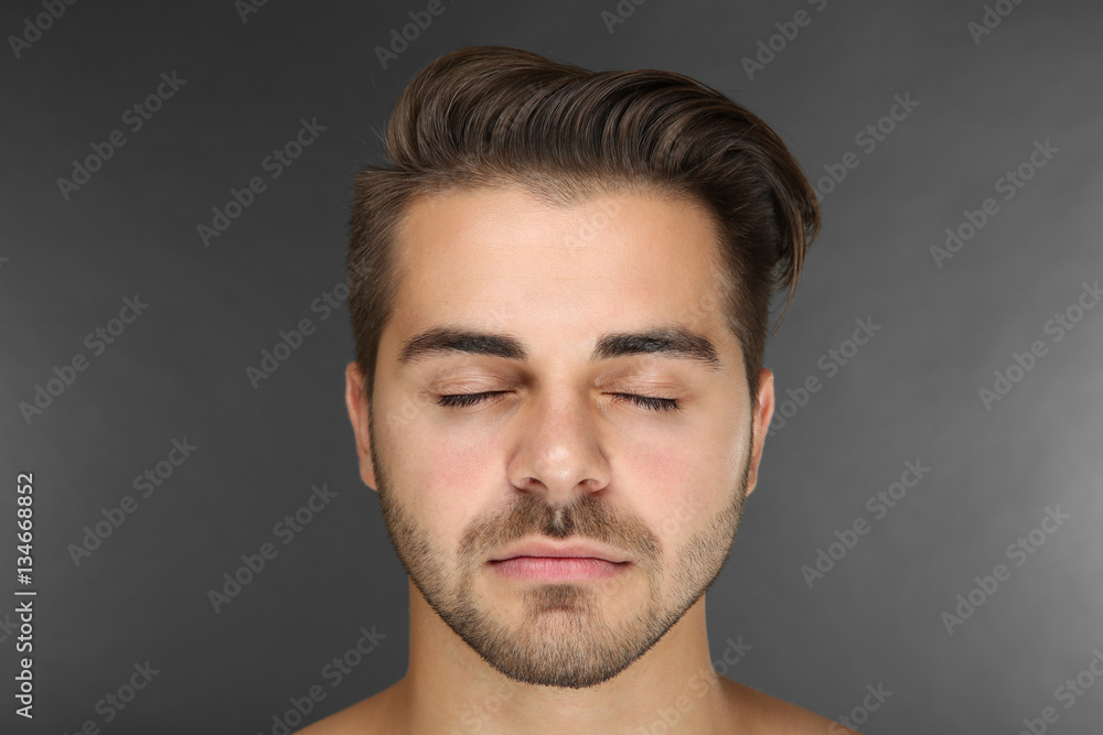 Portrait of young handsome man on grey background Portrait of young handsome man on grey background