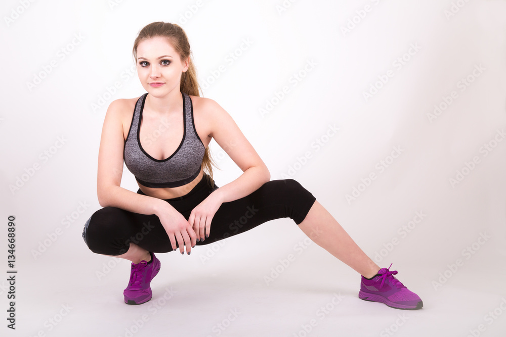 young fit girl stretching in workout clothes. young fit girl stretching in workout clothes.