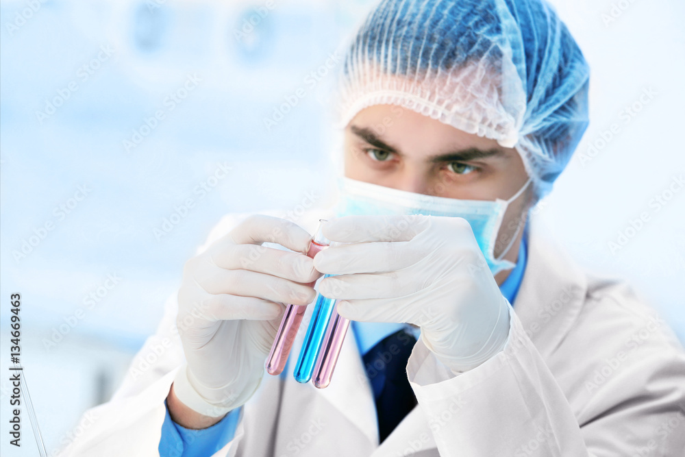Young male scientist making experiments in laboratory Young male scientist making experiments in laboratory